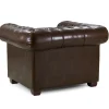 Armchair with scroll arms and metallic studs in brown leather finish Traditional Chesterfield armchair with deep tufting and wooden frame