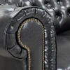 Chesterfield black leather-look sofa in living room setting